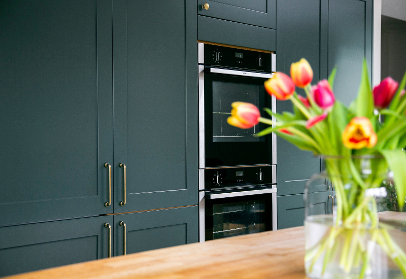 Dark Green Shaker Kitchen with tall cabinets and double oven. Designed by John Willox Kitchen Design