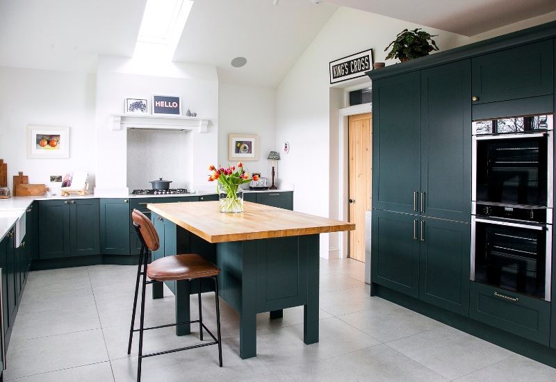 Dark Green Shaker Kitchen, U shaped. island breakfast bar with wood worktop. Designed by John Willox Kitchen Design