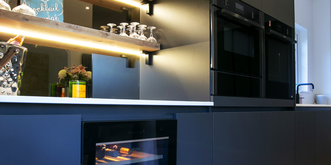 Black Kitchen with wine fridge and bar area. Tall Feature Image. Designed by John Willox Kitchen Design