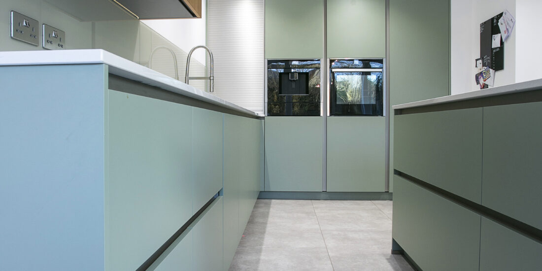 Sage, Steel and Oak Kitchen. Tall Feature Image. Designed by John Willox Kitchen Design.