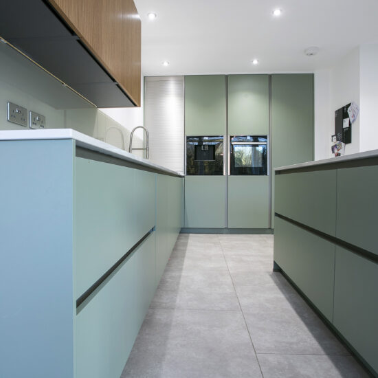 Sage, Steel and Oak Kitchen. Tall Feature Image. Designed by John Willox Kitchen Design.