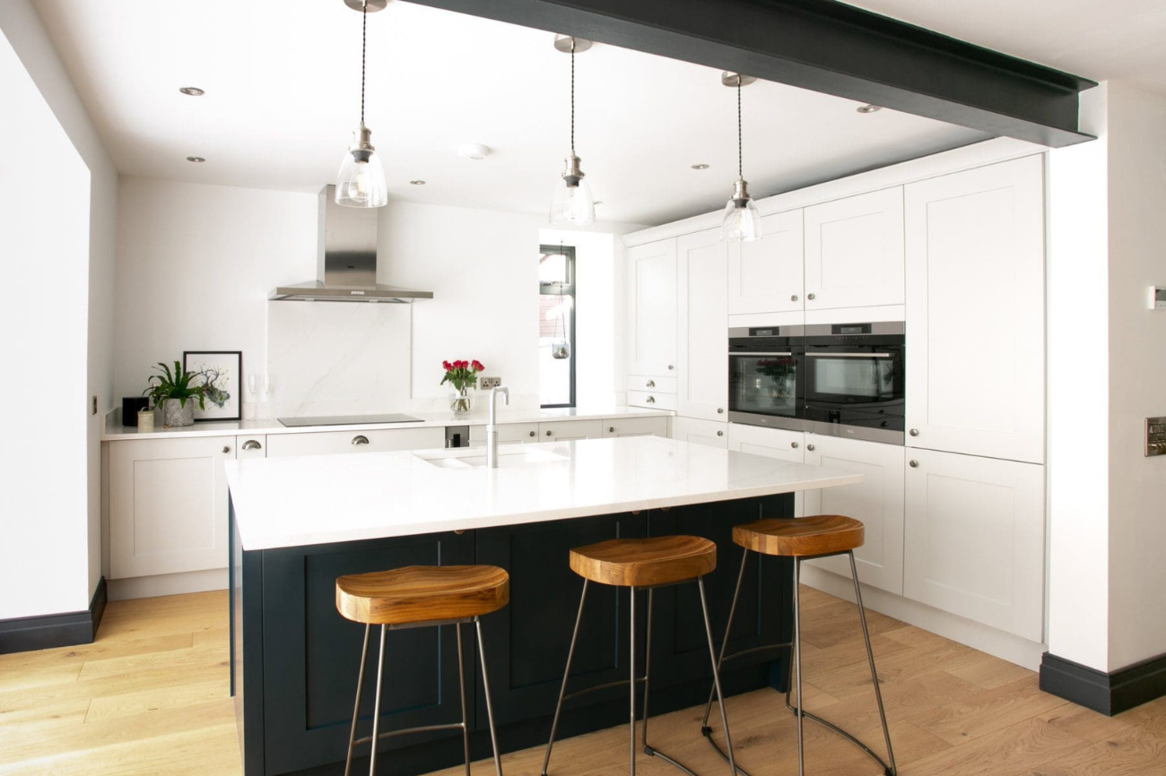 White shaker kitchen with dark grey shaker on the island. Design by John Willox Kitchen Design.