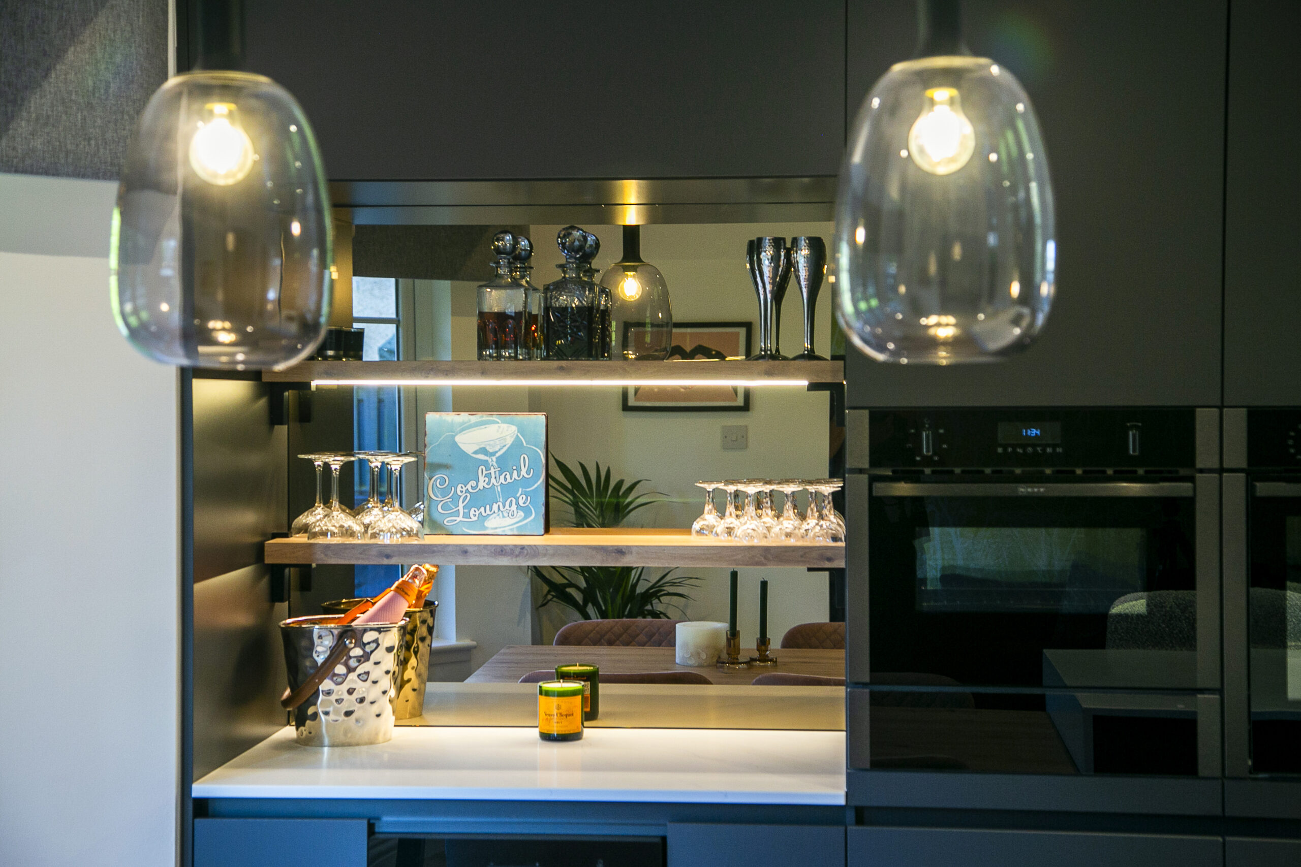 Bar Areas and serving space with mirrored glass wall by John Willox Kitchen Design, Ellon, Aberdeenshire