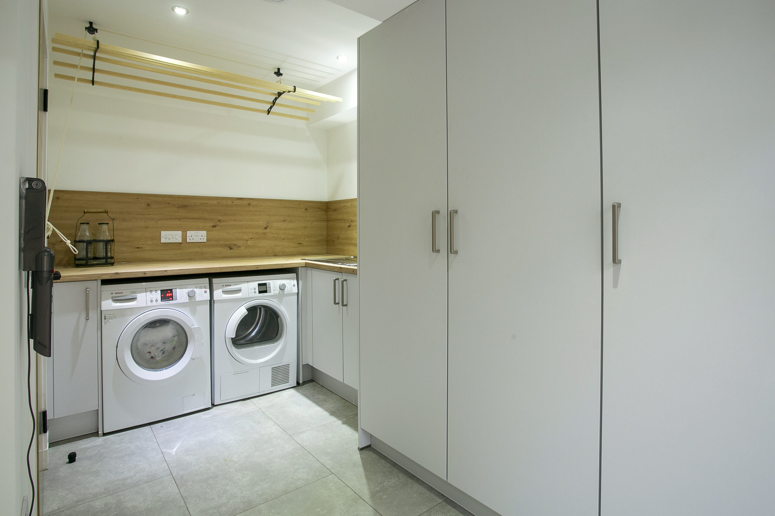 White matt utility space with oak worktops Boot Room and Utility Spaces by John Willox Kitchen Design, Ellon, Aberdeenshire