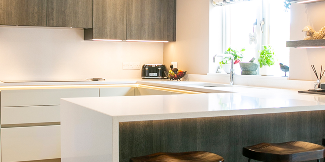 Open plan kitchen with white and timber effect. Feature Image 1. Designed by John Willox Kitchen Design.