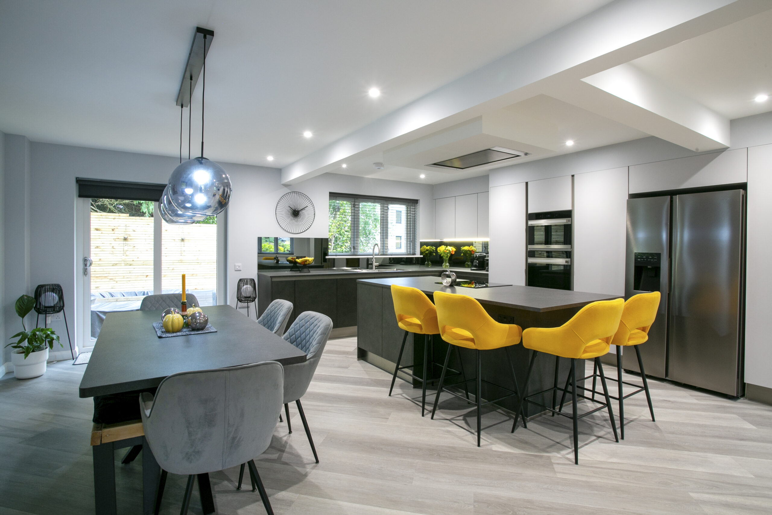 Kitchen Extension Aberdeen. John Willox Kitchen Design Aberdeen. Ellon. Mocca and Grey Matt Kitchen. Smoked Mirror Splashback. Large L-Shaped Kitchen with Kitchen Island. Space for Dining Table and Breakfast Bar.