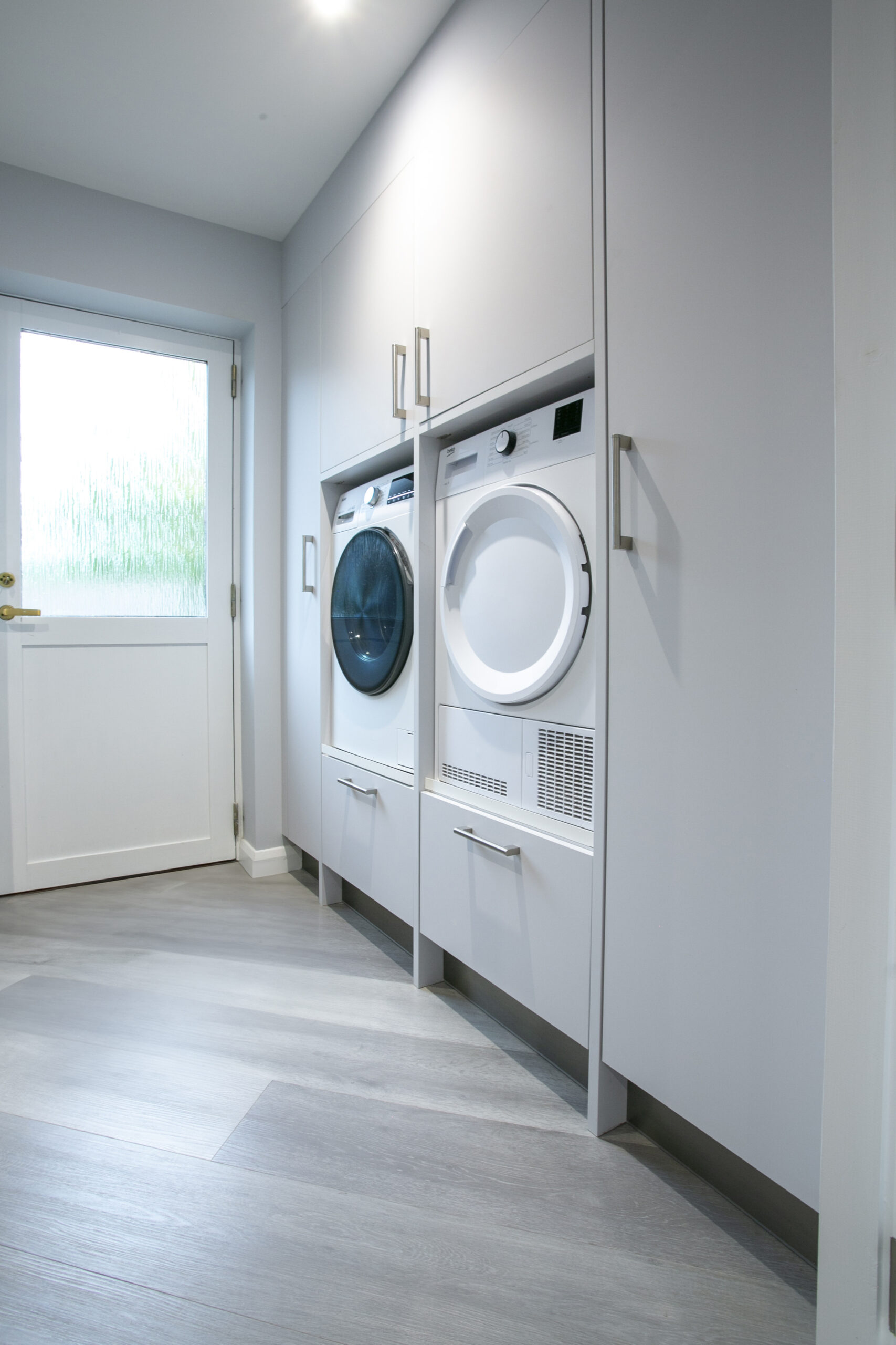 White Utility Space. Laundry Room. Tall cabinets. ohn Willox Kitchen Design Aberdeen. Ellon.