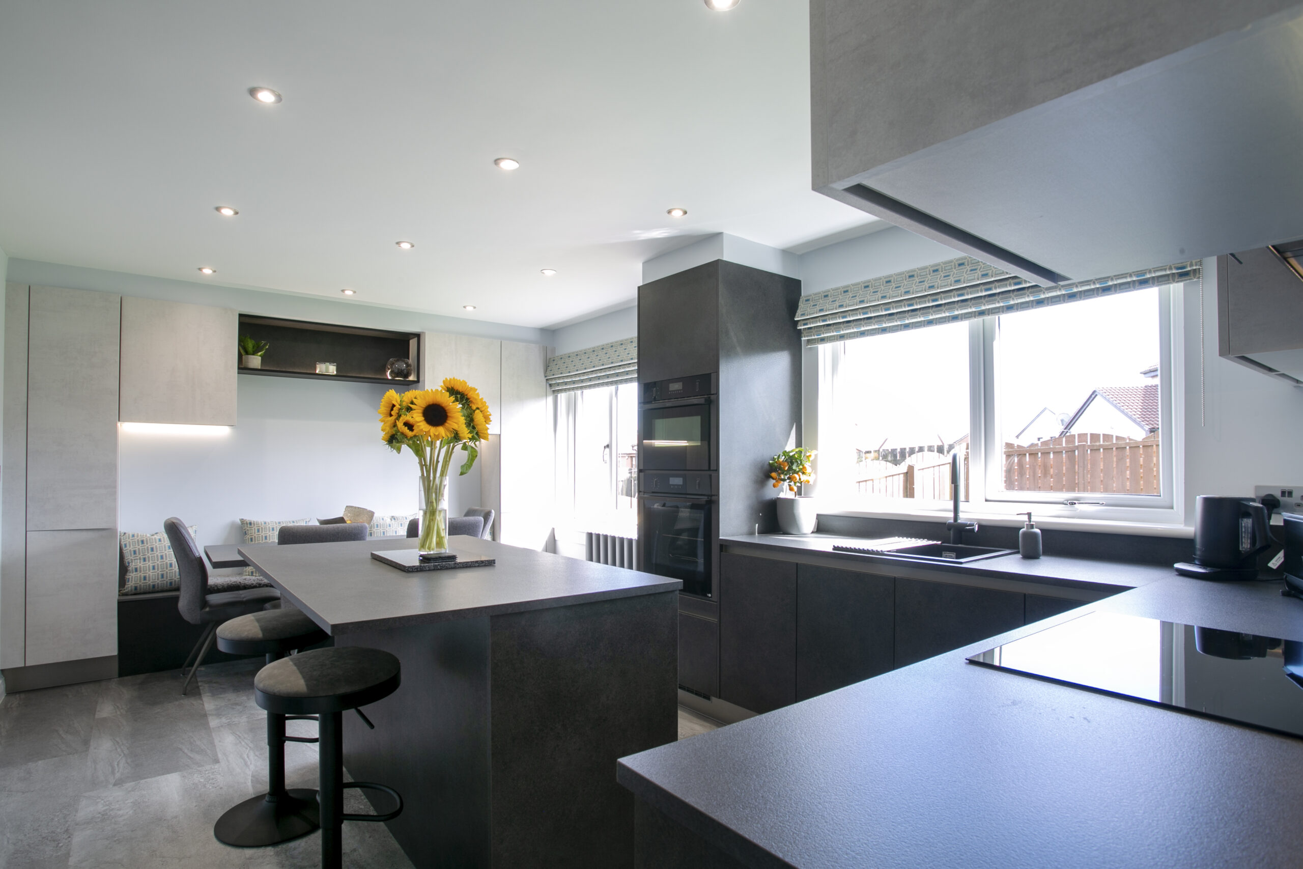 Wide shot of Mocca and white concrete kitchen design in peterhead, aberdeenshire. open plan kitchen diner with an island in peterhead, aberdeenshire. John Willox Kitchen Design Aberdeen. Ellon.