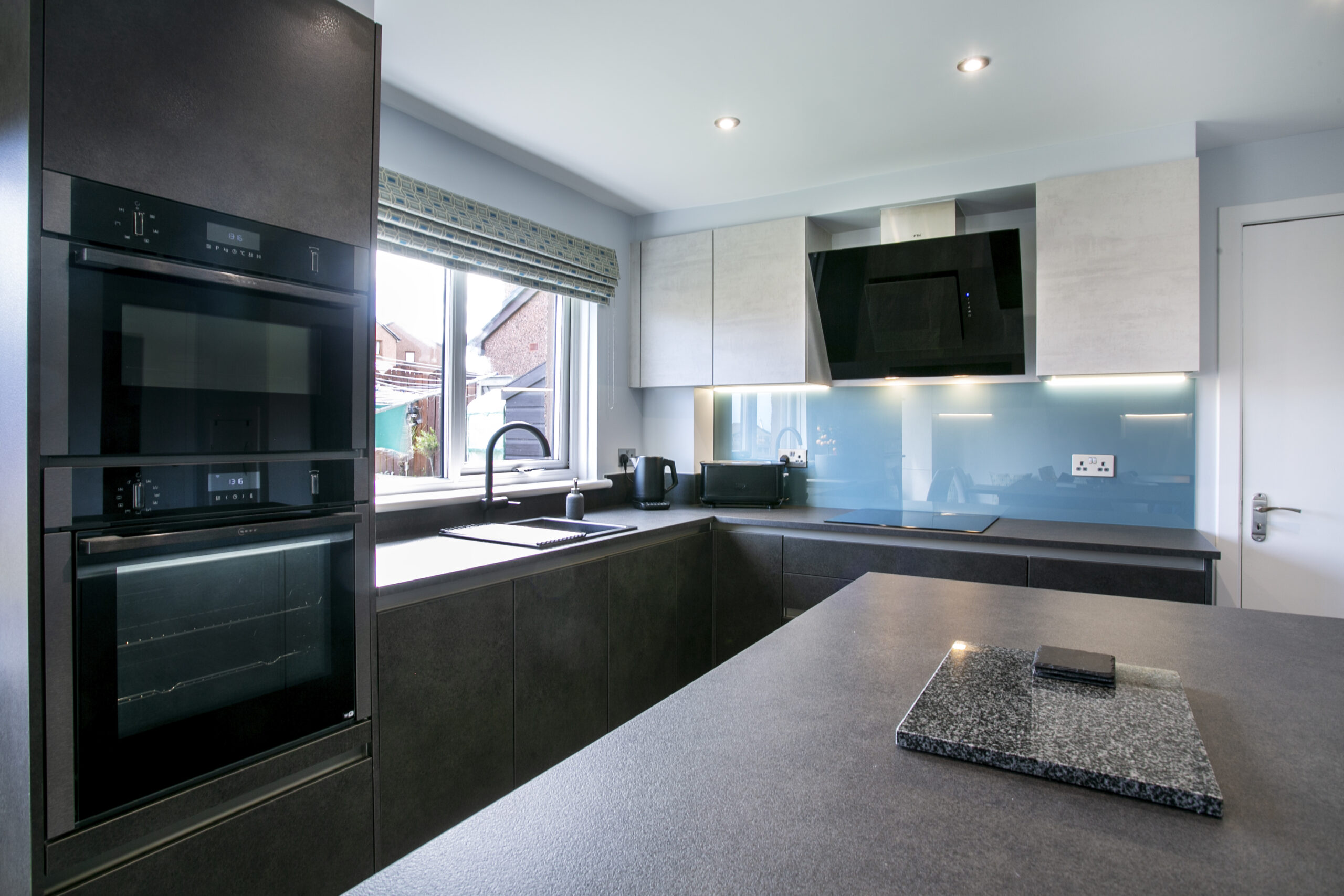 Close up of Mocca and white concrete kitchen in peterhead, aberdeenshire. open plan kitchen diner with an island in peterhead, aberdeenshire. John Willox Kitchen Design Aberdeen. Ellon.