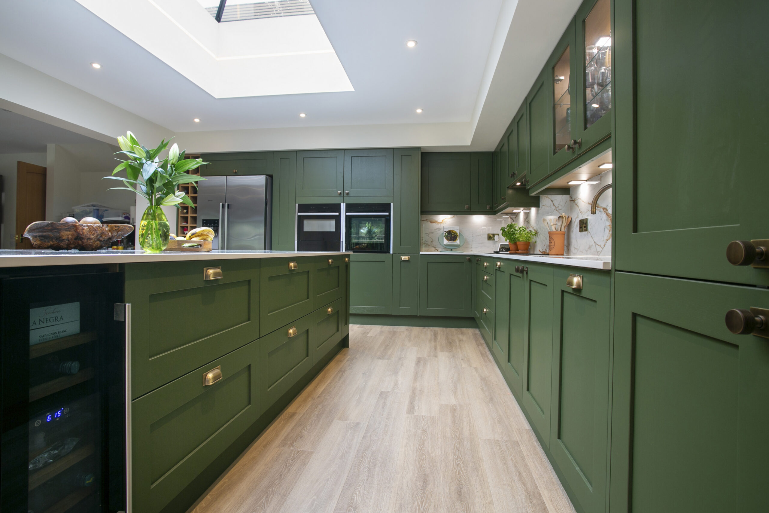 Open plan kitchen Design with large island. Bespoke Green Shaker Kitchen Design. John Willox Kitchen Design Aberdeen. Ellon. Green Kitchen. Large L-Shaped Kitchen.