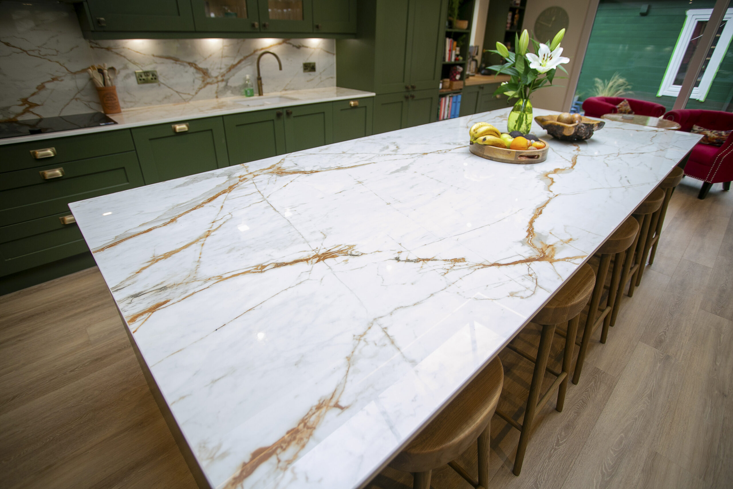 Bespoke Green Shaker Kitchen Design with Dekton Awake worktops and splashbacks. Bronze Handles. Bronze Tap. John Willox Kitchen Design Aberdeen. Ellon. Large L-Shaped Kitchen.