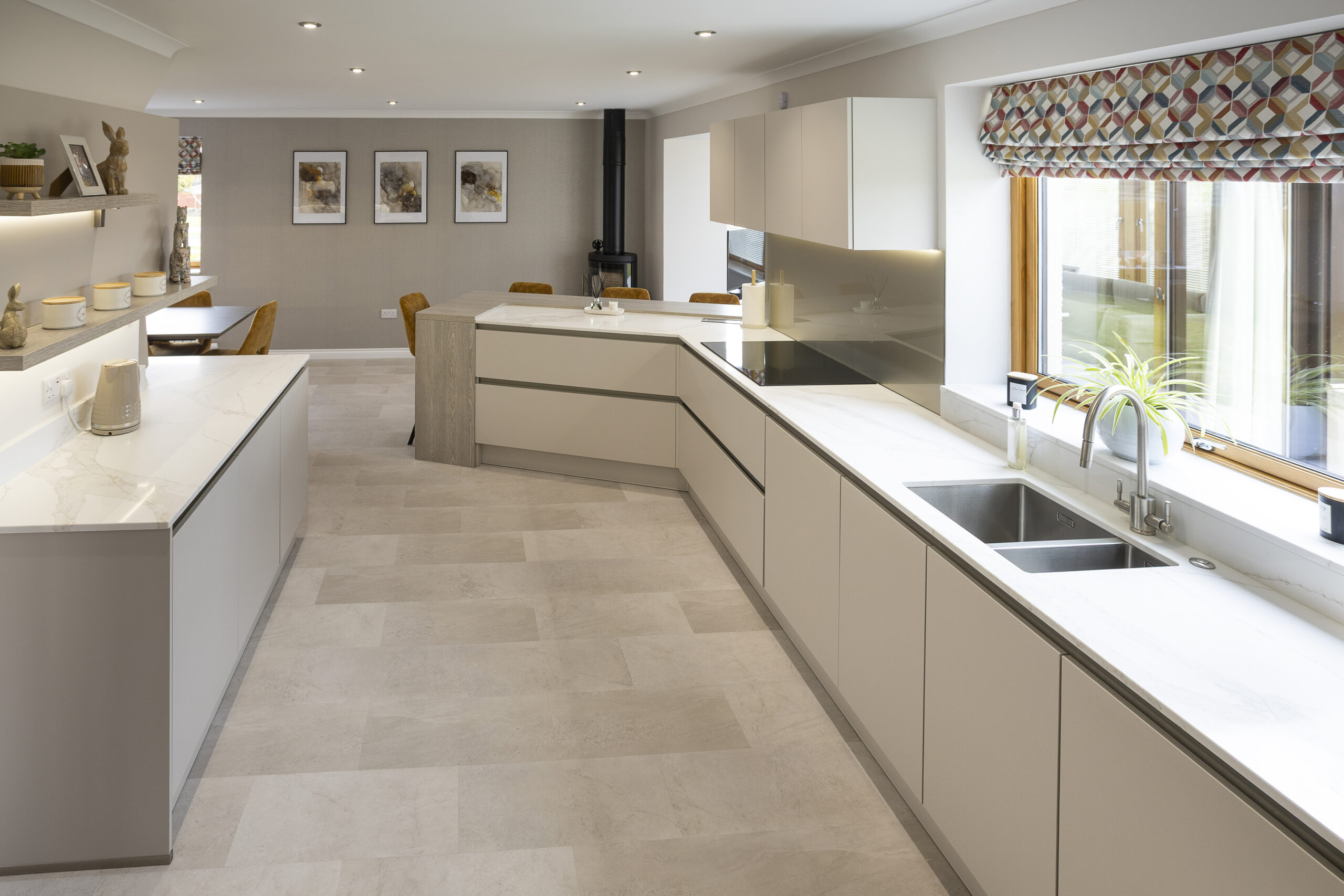 Double sink, smooth surfaces, open shelving. Family Focused Kitchen, Warm neutrals, John Willox Kitchen Design, Ellon, Aberdeen. Facebook Schema Image