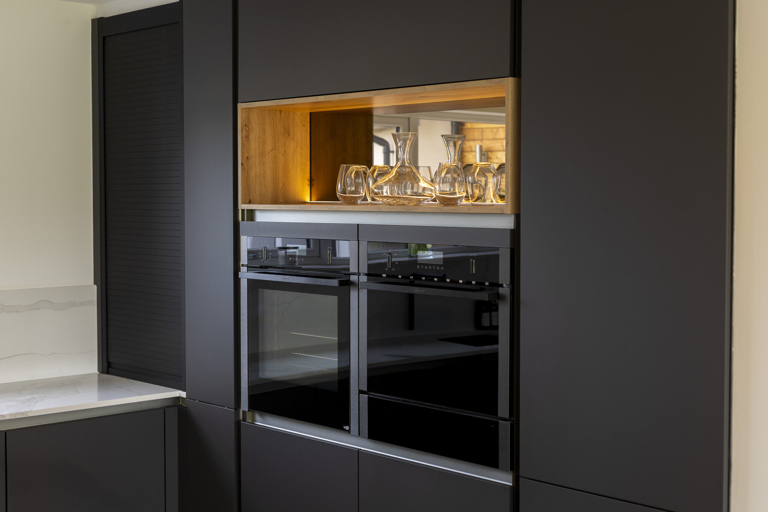 Carbon Black Kitchen. Backlit bronze-mirror shelving. John Willox Kitchen Design, Ellon, Aberdeen.